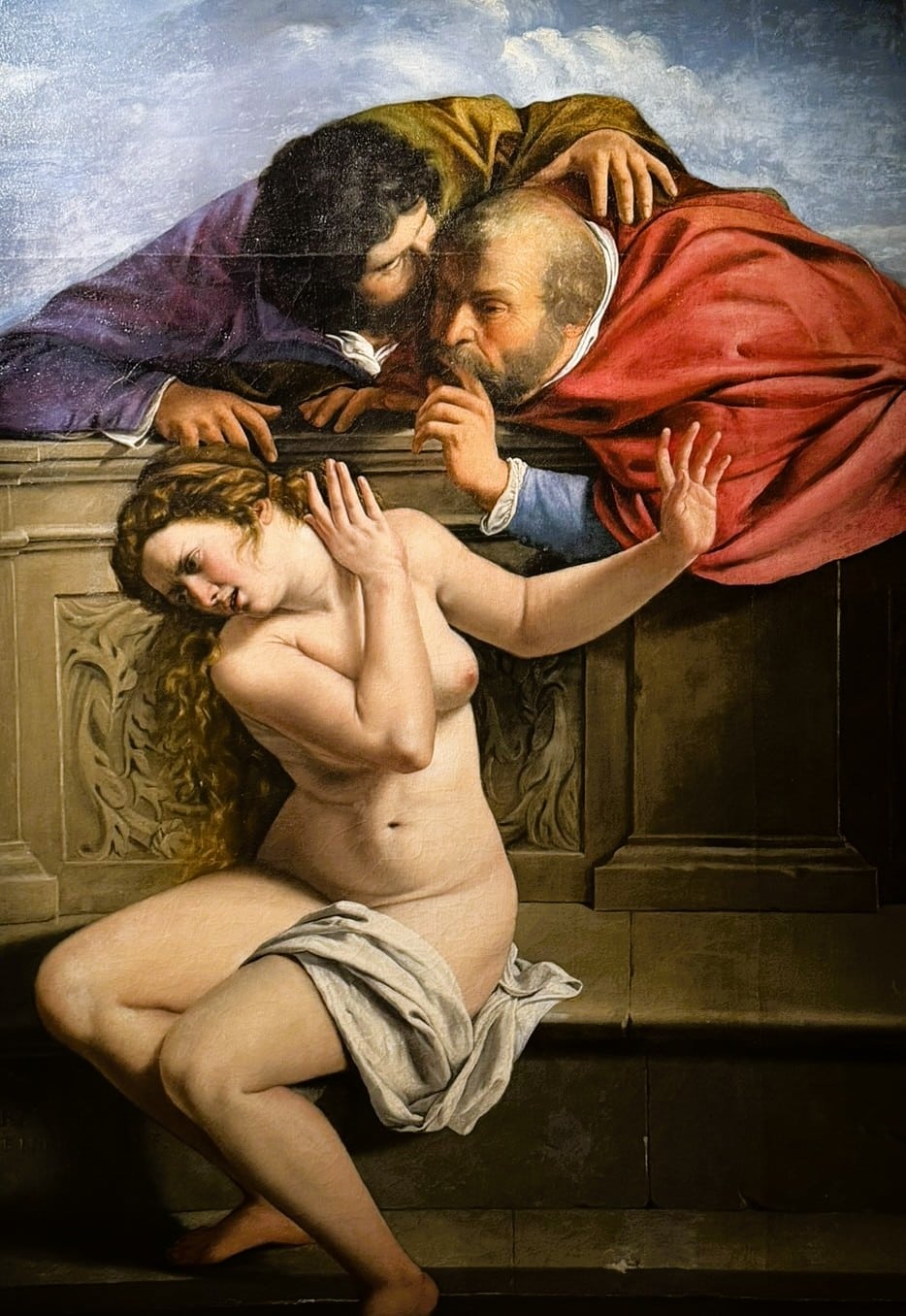Artemisia Gentileschi's Susanna and the Elders, with two men leaning over a wall above Susanna