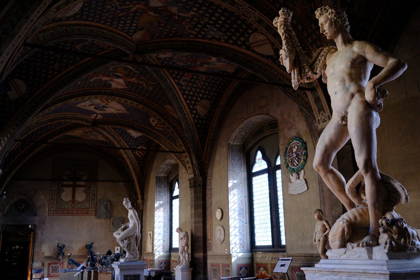 Michelangelo's marble Bacchus in a painted hall of the Bargello