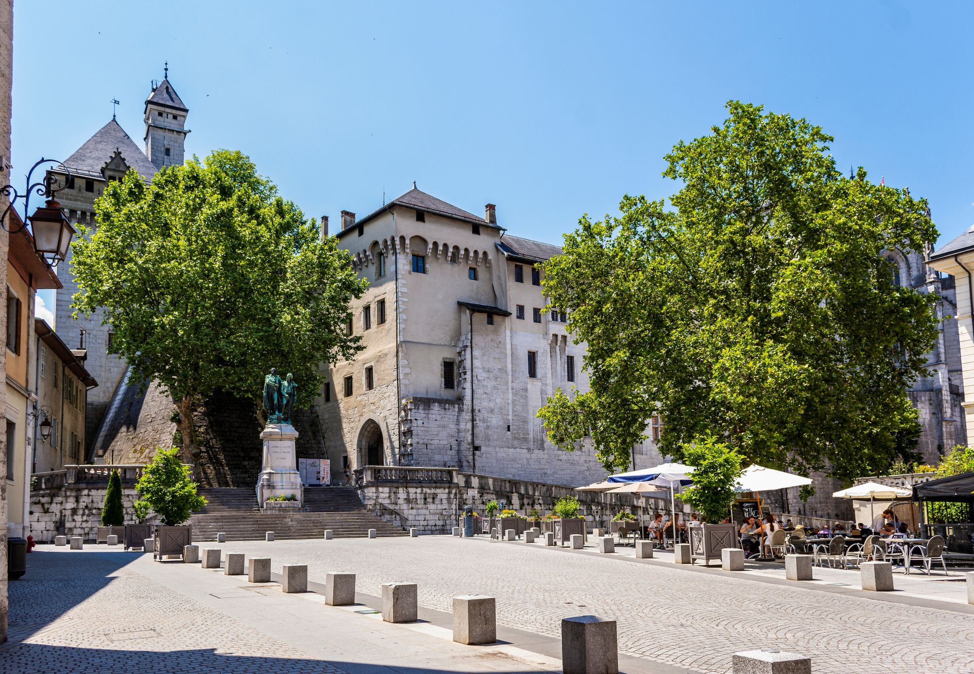 The stone walls and towers of the Château des Ducs de Savoie above a square in Chambéry