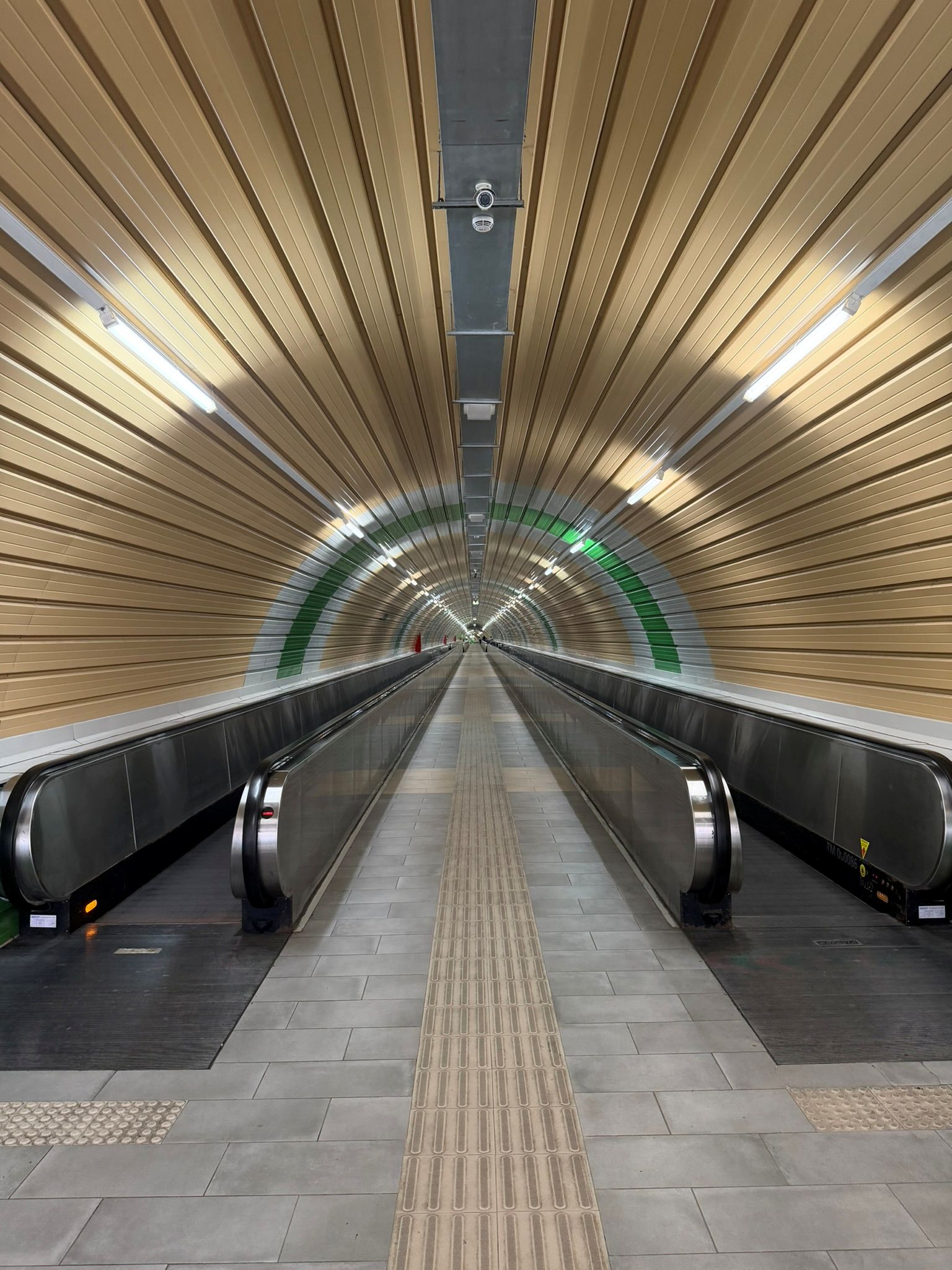 Escalators and a moving walkway inside Spoleto's covered pedestrian link