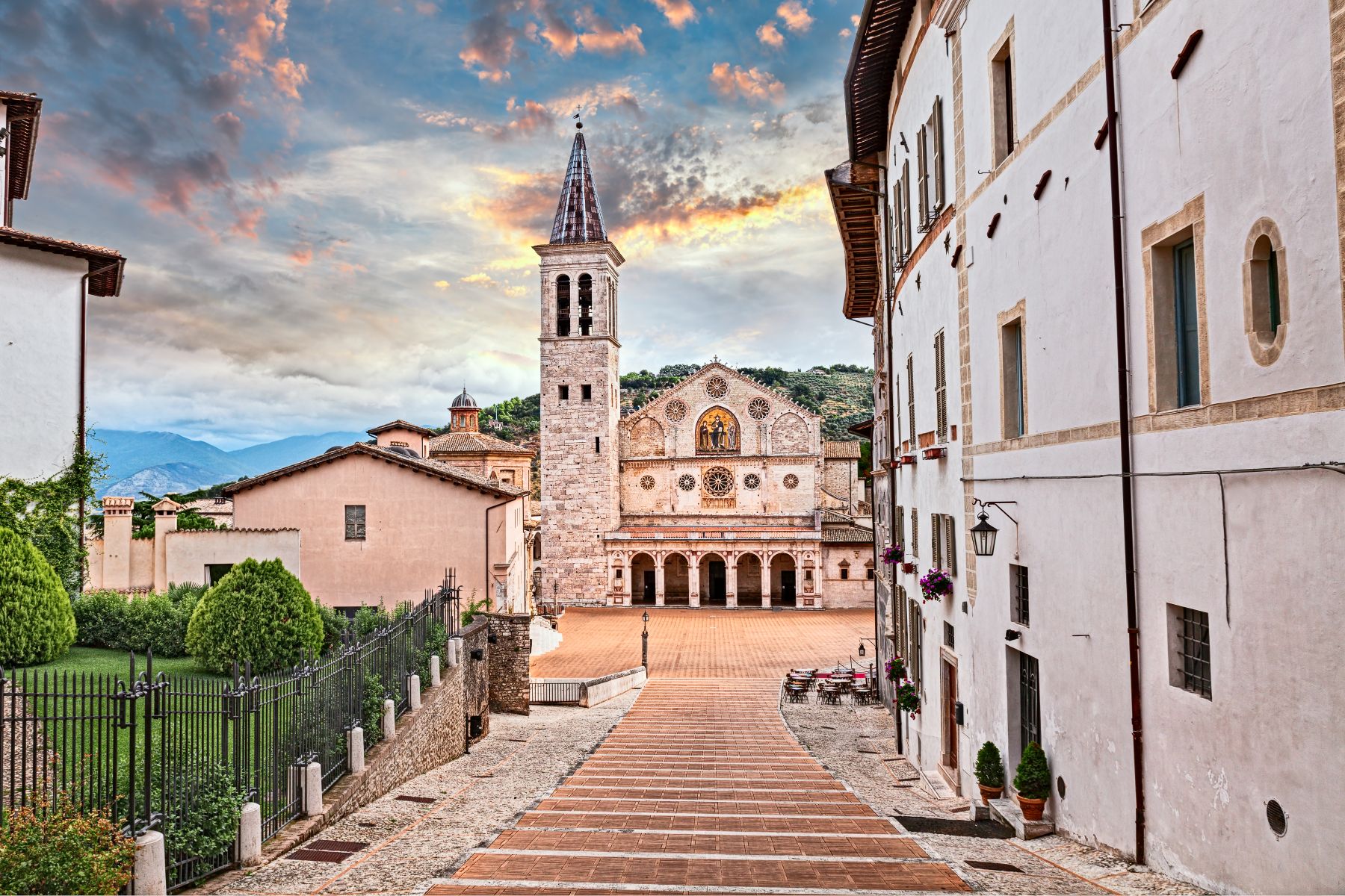 Spoleto Cathedral at the foot of a broad staircase, with its bell tower, rose window and mosaic